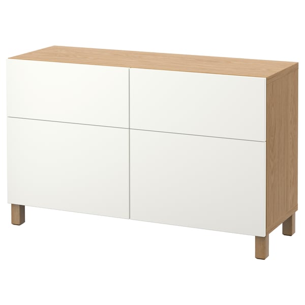 A white and wood BESTÅ storage unit with four doors, offering versatile storage with a modern design.