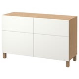 A white and wood BESTÅ storage unit with four doors, offering versatile storage with a modern design.
