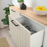 A modern storage cabinet with adjustable shelves and glass doors. One door is open, revealing a metal basket inside.
