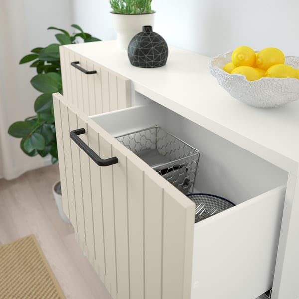 White BESTÅ cabinet with open drawer, containing metal basket.