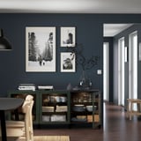 Dining room with blue walls, wood floor, green sideboard, and three pictures.
