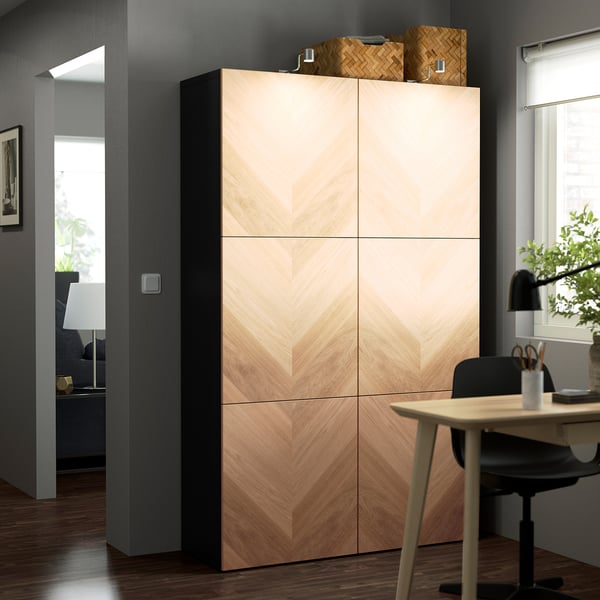 Wooden BESTÅ cabinet in home office with baskets.