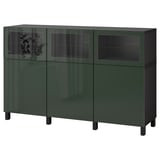 Green BESTÅ sideboard with adjustable shelves and glass doors for storage and display.