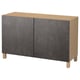 A BESTÅ sideboard in dark grey and oak. It has two large doors and four wooden legs.