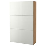 A BESTÅ storage unit in white with light wood sides. It six large, adjustable shelves behind closed doors.