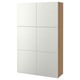 A BESTÅ storage unit in white with light wood sides. It six large, adjustable shelves behind closed doors.