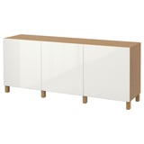BESTÅ white sideboard with wooden top and legs, rectangular shape. Minimalist design, flat surfaces, four white doors.