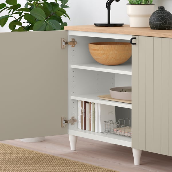 Eral sideboard with shelves, bowl, books, fabric basket, and potted plants.