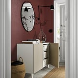 Adjustable shelf & drawer sideboard with soft-close door against burgundy wall.