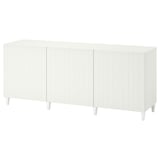 A white BESTÅ sideboard with vertical grooves, four tapered legs, and no visible handles.