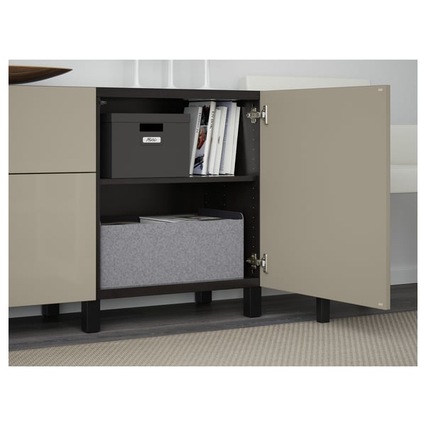 Open storage cabinet with shelves holding storage boxes and books, part of a BESTÅ unit.