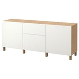 This image shows an IKEA BESTÅ sideboard in white with wooden accents. It two drawers and three cabinet sections with a sleek, minimalist design.