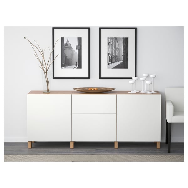 Modern living room sideboard with drawers and soft closing doors, displaying decorative items.