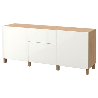 White and oak BESTÅ sideboard. Three shelves, two drawers, light wooden legs.