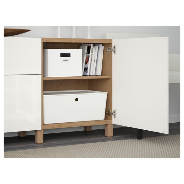 White storage unit with open doors, shelves, bins, and labeled boxes.