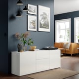 Modern living room with BESTÅ sideboard, orange sofa, grey walls, lamps, and window view.