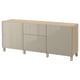 An ikea BESTÅ sideboard in white with wooden legs, featuring three sections: two with glass doors and one open shelf.