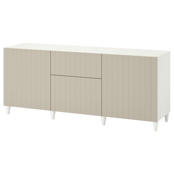 BESTÅ sideboard in white with beige doors, rectangular shape, four legs, and paneled design.