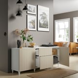 Modern storage unit with open door, shelves, and decor against wall with lamps and window.