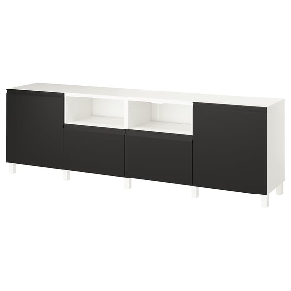 An ikea BESTÅ tv stand in white and black. It has closed storage on the sides and an open shelf in the middle.