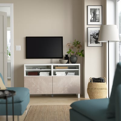 Modern living room with BESTÅ tv bench, teal couch, and decor.