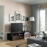 Modern living room with BESTÅ tv bench, flat-screen tv, storage, and plants.