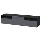 Modern black BESTÅ tv stand with sleek drawers and open shelves for storage and cable management.