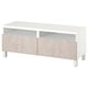 An ikea BESTÅ tv bench in white with marble-effect drawers. It open shelves and cable management.