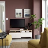 Modern living room with BESTÅ tv stand, organized storage, and a plant.