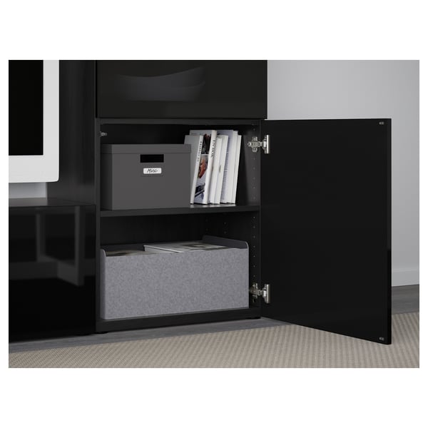 Black BESTÅ cabinet with adjustable shelves, soft-closing doors, and cable management at back.