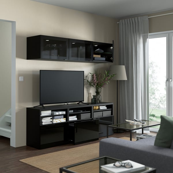 Modern living room with BESTÅ tv unit: flat-screen tv, wall-mounted cabinets, adjustable shelves, and hidden cable management.