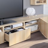 Modern tv stand with drawers open, showcasing organized electronics and media storage. Tv on top, with adjustable shelves and cable management.