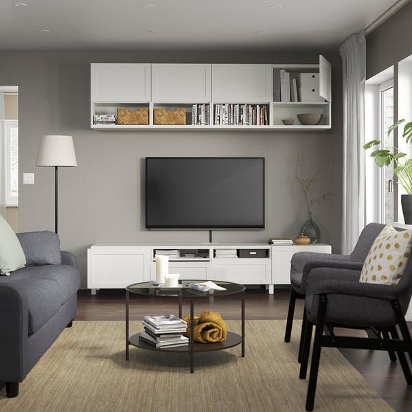Modern living room with BESTÅ tv unit, flat screen, grey sofa & armchair.