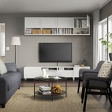 Modern living room with BESTÅ tv unit, flat screen, grey sofa & armchair.