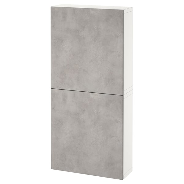 A white and grey BESTÅ wall cabinet with two doors in a concrete finish, designed for storage.