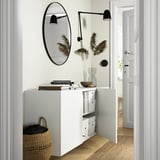 Modern hall with BESTÅ storage, mirror, lamps, wicker basket.