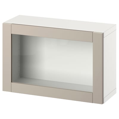 An ikea BESTÅ beige storage unit with a glass door. The rectangular design includes a simple, sleek frame and a glass panel for a modern look.