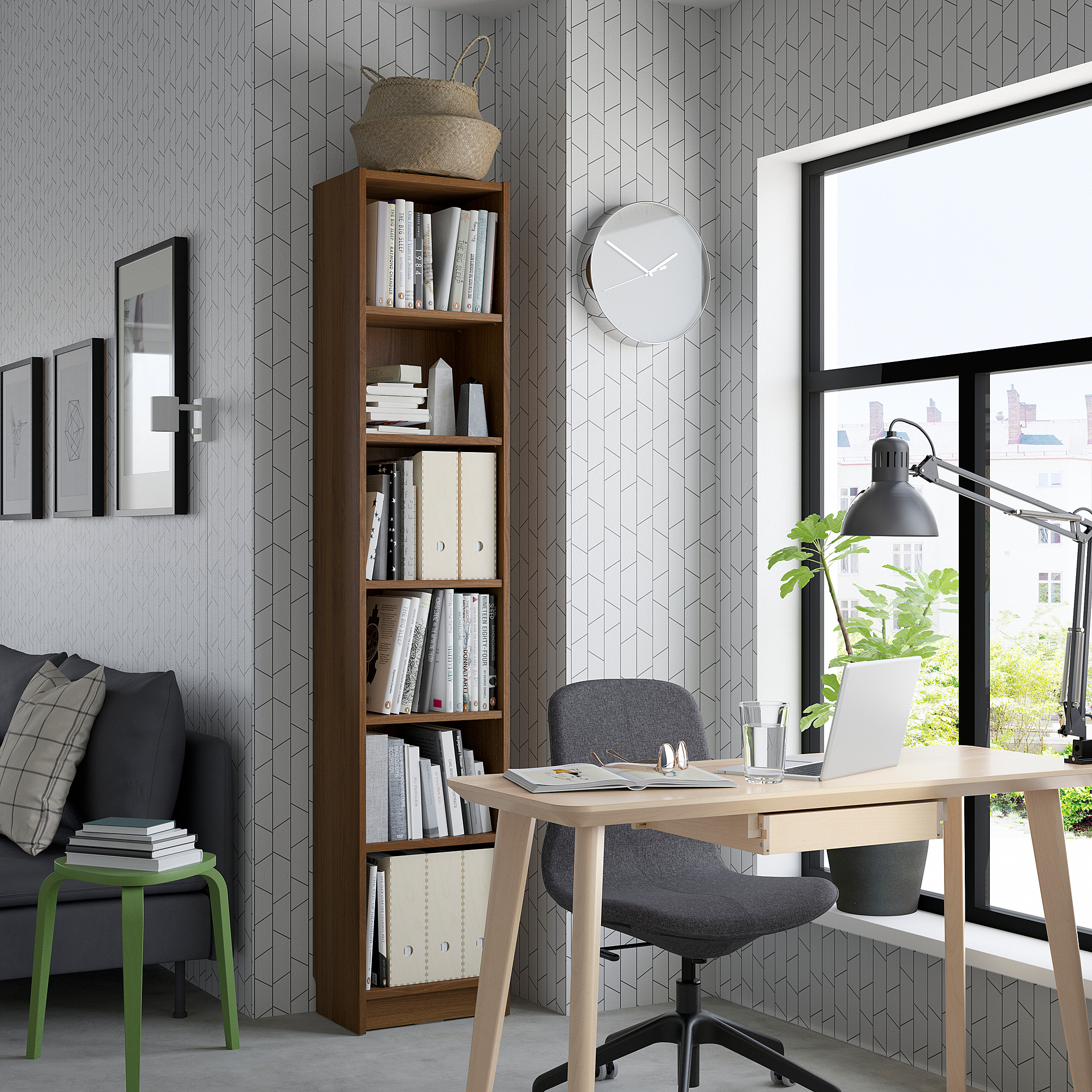 A well-organized home office with a wooden bookcase, office chair at a desk by a window with a laptop and plant, and a cozy sofa with pillows.