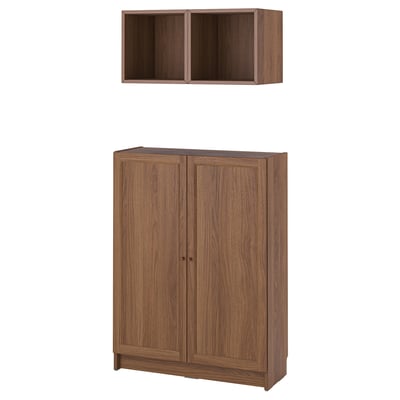 Wooden BILLY bookcase and wall shelf in brown. Two-door cabinet and open cube design for storage.