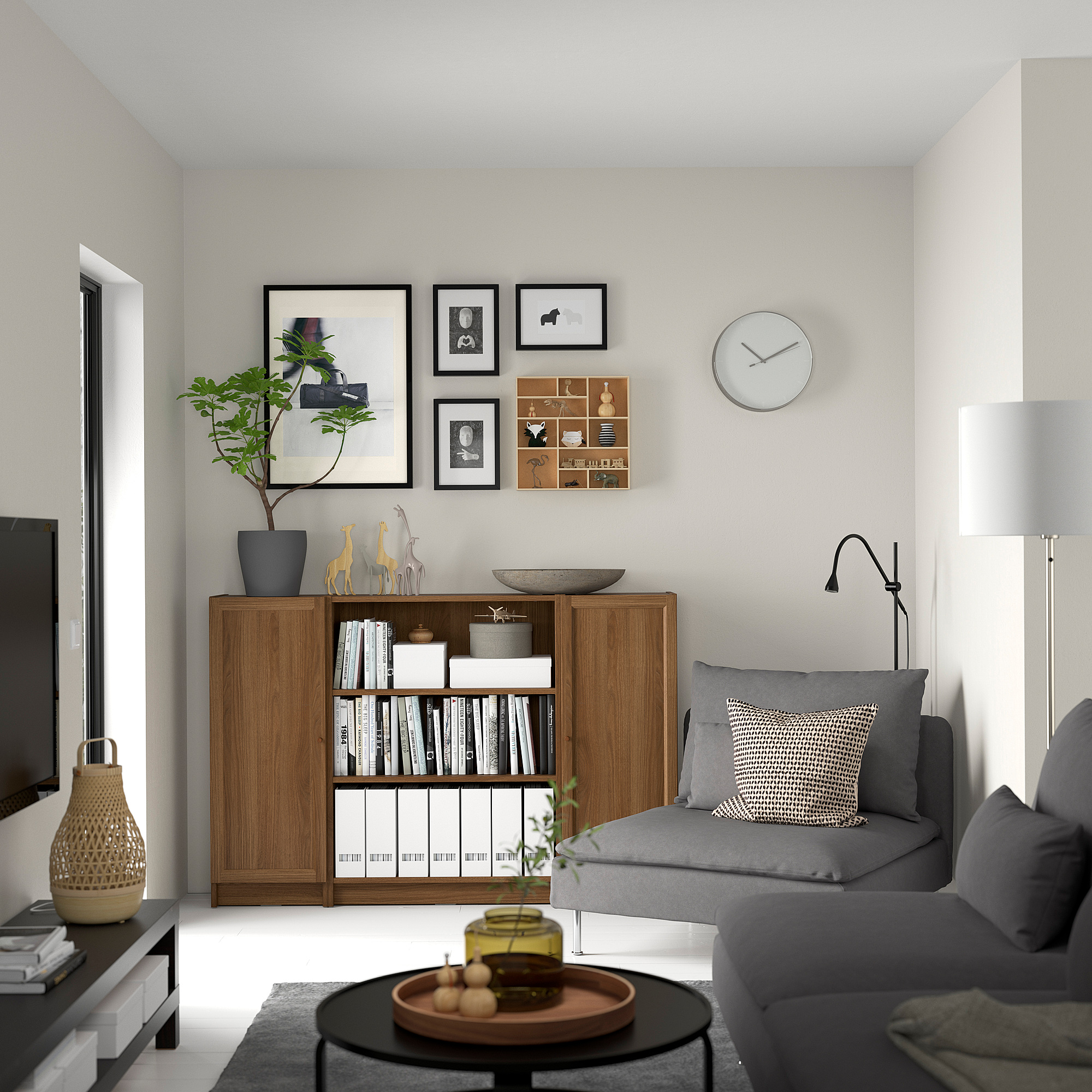 Walnut BILLY bookcase next to gray sofa with decor, clock above, minimalist design.