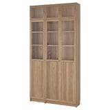 Light brown wooden BILLY bookcase with glass doors, sleek modern design. Tall, rectangular, with adjustable shelves.