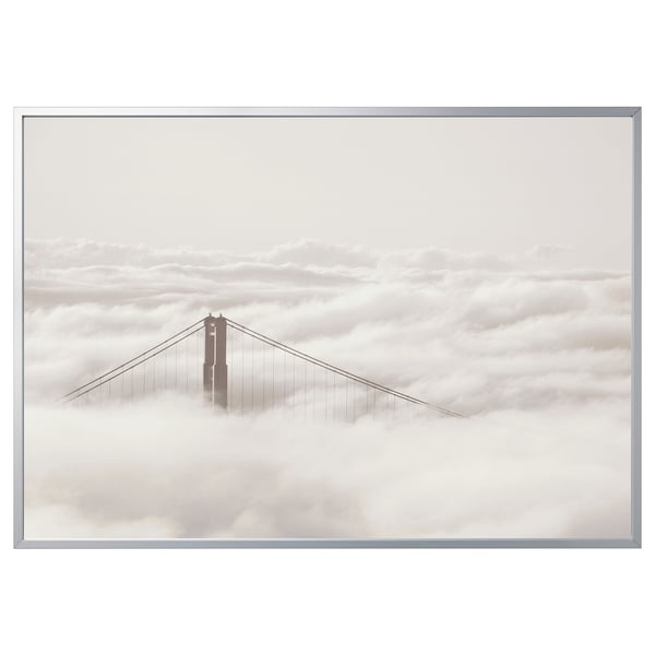 Framed canvas, foggy bridge scene. Silver frame, white clouds, calm atmosphere.