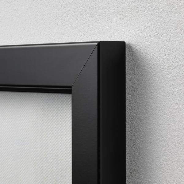 Close-up of a modern black picture frame corner, showing sleek design and quality craftsmanship.
