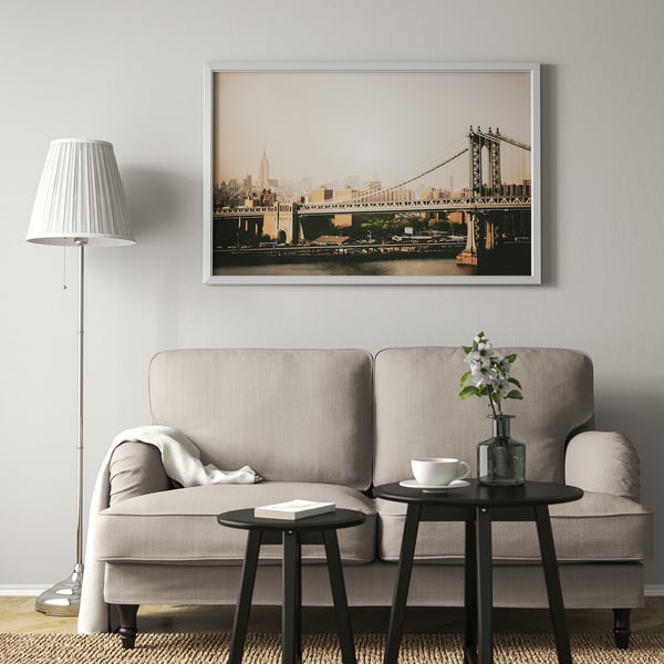 Large framed a bridge in a cozy living room with a gray sofa.