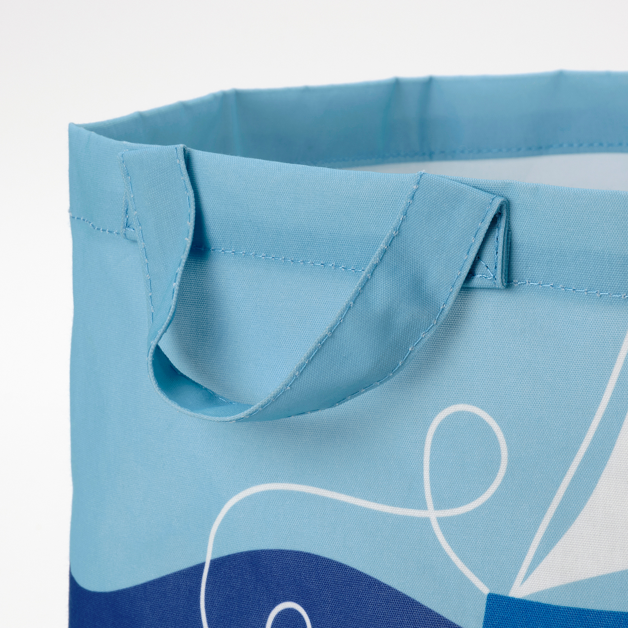 Light blue reusable bag with white and dark blue ocean-themed design. Sturdy handles and neat stitching. Eco-friendly, made from recycled materials.