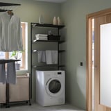 Laundry corner with BOAXEL storage, washer dryer, and drying rack.