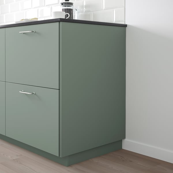 Grey-green recycled kitchen cabinet with metal handles, two drawers.