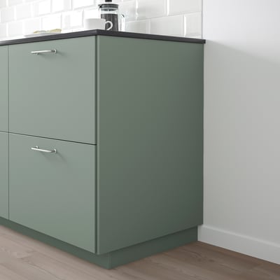 Grey-green BODARP recycled kitchen cabinet with two drawers and countertop.