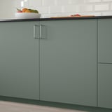 Modern kitchen with grey-green BODARP cabinets and fruit bowl.