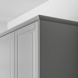 Kitchen cabinet top with grey BODBYN trim, concealing lighting and cords.